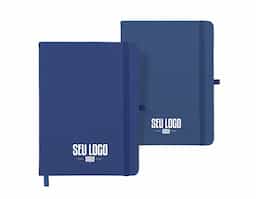 Caderneta tipo moleskine emborrachado com porta caneta em nylon, marcador de página em cetim e fita elástica para lacre. Contém aproximadamente 80 folhas pardas com pauta.