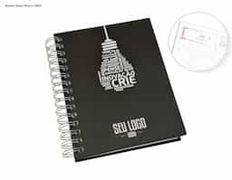 Agenda Wire-o com Capa Prime preta, decorada com uma estampa motivacional. Modelo diário 2025, oferece páginas datadas para organização de tarefas e compromissos. Possui encadernação resistente e design compacto, ideal para uso pessoal ou profissional.