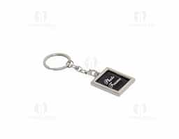 Chaveiro porta-foto em inox. Possui uma fina capa transparente removível para proteger a foto e corrente com gancho preto ao chaveiro.